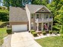 Lovely home with a well-kept lawn and landscaping, an attached garage, and a charming front porch at 812 Thornapple Ct, Lake Wylie, SC 29710