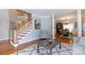 Inviting living space featuring a staircase, hardwood floors, neutral color palette, and elegant furnishings at 905 Patricians Ln, Monroe, NC 28110