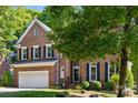 Lovely two-story brick home featuring mature trees, manicured lawn and a 2 car garage at 909 Staghorn Ln, Waxhaw, NC 28173