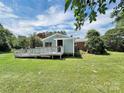 Spacious backyard featuring a large deck with access to the home's rear entrance at 104 Tobe Bridge Rd, Kings Mountain, NC 28086