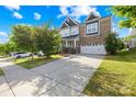 Attractive two-story home with brick accents, a spacious driveway, and neatly maintained landscaping at 10693 Sky Chase Nw Ave, Concord, NC 28027