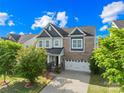 Charming two-story home with a brick and siding exterior, complemented by a well-kept lawn and established trees at 10693 Sky Chase Nw Ave, Concord, NC 28027
