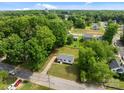 Aerial view of a charming one-story home surrounded by lush trees in a quiet neighborhood at 109 Jackson St, Salisbury, NC 28144