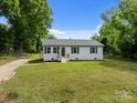 Charming one-story home with a well-maintained lawn and inviting entrance on a sunny day at 109 Jackson St, Salisbury, NC 28144
