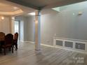 Spacious dining area featuring wood floors, paneled walls, and natural light at 10901 Claude Freeman Dr, Charlotte, NC 28262