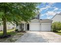 Charming two-story home boasts a well-manicured lawn and two-car garage at 10901 Claude Freeman Dr, Charlotte, NC 28262