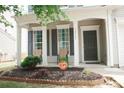 A cozy front porch featuring decorative columns, a flower bed, and an CPI security sign at 10901 Claude Freeman Dr, Charlotte, NC 28262