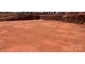 A spacious building site with red dirt is ready for a new home at 1099 Sugar Creek Rd, Indian Land, SC 29707