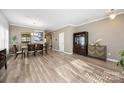 Bright and airy living room featuring hardwood floors, a dining table, and elegant decor at 1125 Jasmine Dr, Fort Mill, SC 29707