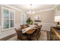 Cozy dining room featuring six upholstered chairs, a wooden table, and stylish window shutters at 113 Callandor Ct, Troutman, NC 28166