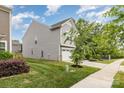 This home boasts a well-maintained lawn and a two-car garage with extra yard space at 1313 Forkhorn Dr, Monroe, NC 28110