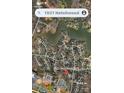 Aerial view of a neighborhood with tree-lined streets and homes near a lake, as seen from above at 1921 Notchwood Ct, Clover, SC 29710