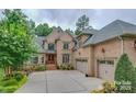 Elegant home with a meticulously kept lawn, complemented by the charming curb appeal of the landscaping at 1921 Notchwood Ct, Clover, SC 29710