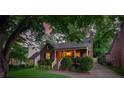 Quaint brick home with covered porch and lush greenery provides a welcoming and serene setting at 2124 Chambwood Dr, Charlotte, NC 28205