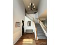 Welcoming foyer with hardwood floors, staircase, chandelier, and accent furniture at 2330 Winthorp Ridge Rd, Charlotte, NC 28270