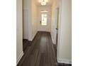 Bright hallway with wood-look flooring, board and batten trim, and natural light through the front door at 3011 Buffett Ln # 33, Monroe, NC 28110