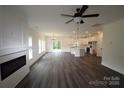 Spacious living room and kitchen featuring an open layout, modern fireplace, and wood-look flooring at 3011 Buffett Ln # 33, Monroe, NC 28110