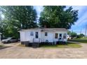 Rear exterior view featuring dual entrances, quaint stairs, and spacious parking at 309 E 11Th St, Kannapolis, NC 28083