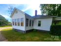 Exterior side view shows sunroom addition with many windows for natural light at 309 E 11Th St, Kannapolis, NC 28083
