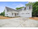 Beautiful home with a large driveway and three-car garage, perfect for the modern Gathering at 3622 E Brief Rd, Monroe, NC 28110