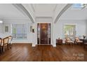 Elegant foyer with high ceilings, hardwood floors, and a decorative front door with sidelights at 409 Wheatberry Hill Dr, Matthews, NC 28104