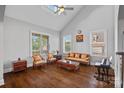 Bright living room with vaulted ceilings, hardwood floors, and large windows allowing ample natural light at 409 Wheatberry Hill Dr, Matthews, NC 28104