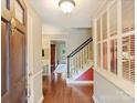 Inviting foyer with hardwood floors, staircase and natural light at 4464 Mullens Ford Rd, Charlotte, NC 28226