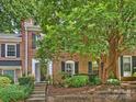 Charming brick townhome with lush landscaping and a welcoming entrance at 4464 Mullens Ford Rd, Charlotte, NC 28226