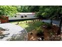 A single-story home featuring a manicured lawn, mature trees, and a gravel driveway at 475 Dot Faris Rd, Catawba, SC 29704