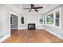Bright living room with a fireplace, hardwood floors, and multiple windows offering ample natural light at 506 7Th Sw St, Hickory, NC 28602