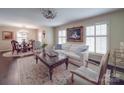 Bright living room boasts stylish furnishings, dark hardwood floors, and a view into the dining area at 5411 Valley Forge Rd, Charlotte, NC 28210