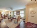 Inviting living room featuring elegant furniture, hardwood floors, and abundant natural light from shuttered windows at 5411 Valley Forge Rd, Charlotte, NC 28210