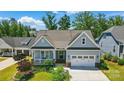 Lovely single-Gathering home with a welcoming front porch, two-car garage, and professionally landscaped yard at 6136 Sandy Point Ln, Belmont, NC 28012