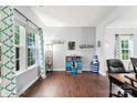 Bright living room with hardwood floors, large windows, and playful decor at 865 Wingthorn Rose Dr, Gastonia, NC 28056