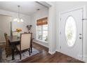 Bright dining area with hardwood floors, stylish lighting, and a view of the outdoors at 10217 Falling Leaf Dr, Concord, NC 28027