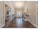 Spacious hallway showcasing hardwood floors and a charming view of the home's entrance at 1022 Curling Creek Dr, Indian Trail, NC 28079