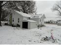 Rear exterior of a charming home with a backyard shed and snow-covered yard at 1105 Horton Ave, Kannapolis, NC 28083