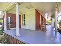 Spacious covered front porch showcasing ample seating area, perfect for relaxing and enjoying the outdoors at 1105 S Point Rd, Belmont, NC 28012