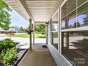 Inviting front porch with craftsman columns and decorative hanging plants offering a cozy entryway at 1124 Hunter St, Statesville, NC 28677
