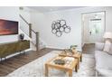 Contemporary living room showcasing hardwood floors, modern furniture, and a staircase leading to upper levels at 12309 Gambrell Dr, Charlotte, NC 28278