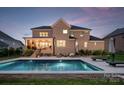 Stunning backyard features a sparkling in-ground pool, patio, and beautifully landscaped surroundings at 1445 Cherry Laurel Dr, Waxhaw, NC 28173
