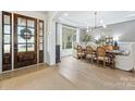 Elegant dining room with hardwood floors, a modern chandelier, and sophisticated decor at 1445 Cherry Laurel Dr, Waxhaw, NC 28173
