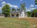 Side view of a white home with a covered front porch and manicured lawn at 1454 King Rd, York, SC 29745