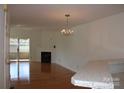 Bright living room with fireplace, chandelier, and sliding door to balcony at 14621 Waterside Dr, Charlotte, NC 28278