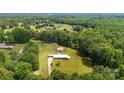 Expansive aerial view of a brick home on a large, wooded lot in a serene neighborhood at 1512 Mount Ulla Hwy, Mooresville, NC 28115