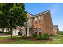 Well-maintained brick home showcasing a lush front yard and classic design elements at 15215 Arleta Cir, Charlotte, NC 28277
