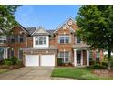 Attractive brick home with a two-car garage, complemented by mature landscaping and a welcoming entrance at 15215 Arleta Cir, Charlotte, NC 28277