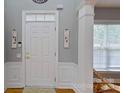 Inviting foyer with hardwood floors, elegant wainscoting, and a well-lit entrance at 15215 Arleta Cir, Charlotte, NC 28277