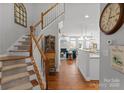 Traditional staircase with hardwood floors leads into an open living and kitchen area at 19143 Juanita Ln, Cornelius, NC 28031