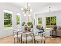 Airy dining area boasting ample natural light, a modern chandelier, and a glass top dining table at 2006 St John St, Charlotte, NC 28216